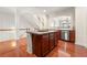 Spacious kitchen with a central island, stainless steel appliances and hardwood flooring, offering a modern and functional design at 282 Autry Mill Ln, Suwanee, GA 30024