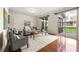 Bright living room with hardwood floors, stylish seating, and natural light, seamlessly connecting to the outdoor living space at 282 Autry Mill Ln, Suwanee, GA 30024