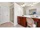 Main bathroom featuring a vanity with cherry cabinets, a white countertop, and shower at 282 Autry Mill Ln, Suwanee, GA 30024