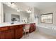 Bright main bathroom with double sinks, separate soaking tub, and large windows at 282 Autry Mill Ln, Suwanee, GA 30024