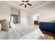 Spacious main bedroom featuring wood floors, a ceiling fan, and ensuite bathroom access at 282 Autry Mill Ln, Suwanee, GA 30024