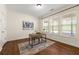 Well-lit home office with a desk, chair, and multiple windows at 282 Autry Mill Ln, Suwanee, GA 30024