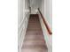Elegant staircase featuring carpeted steps, white trim and an appealing wooden handrail, inviting one to explore the upper floors at 282 Autry Mill Ln, Suwanee, GA 30024