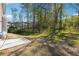 Large backyard with a concrete patio and expansive lawn, providing a great outdoor living space at 2860 Windsor Knoll Dr, Dacula, GA 30019