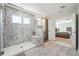 Bathroom featuring a spacious walk-in shower, double vanity, and view into the bedroom that offers a luxurious experience at 2860 Windsor Knoll Dr, Dacula, GA 30019
