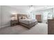 Bedroom with carpeted floor and traditional furniture, including a bed, nightstands, and dresser; natural light from two windows at 2860 Windsor Knoll Dr, Dacula, GA 30019