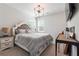 Cozy bedroom with a tufted headboard bed, neutral tones, stylish lighting, and a TV for ultimate comfort at 2860 Windsor Knoll Dr, Dacula, GA 30019