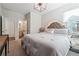 Bedroom featuring a comfortable bed, stylish lighting, and a view to the bathroom for added convenience at 2860 Windsor Knoll Dr, Dacula, GA 30019