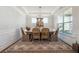 Beautiful dining room with wainscoting, natural light, and seating for six at 2860 Windsor Knoll Dr, Dacula, GA 30019