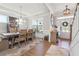 Elegant dining room featuring a large table, stylish chandelier, and ample natural light at 2860 Windsor Knoll Dr, Dacula, GA 30019