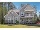 Charming two-story home with a welcoming front porch and well-manicured lawn at 2860 Windsor Knoll Dr, Dacula, GA 30019