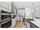 Modern kitchen with stainless steel appliances, quartz countertops, and ample storage at 2860 Windsor Knoll Dr, Dacula, GA 30019