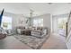Inviting living room with a large sectional sofa, neutral carpet, and bright windows offering ample light at 2860 Windsor Knoll Dr, Dacula, GA 30019