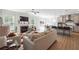 Spacious living room open to a modern kitchen and dining area, featuring a fireplace, TV, and lots of natural light at 2860 Windsor Knoll Dr, Dacula, GA 30019