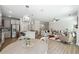 Open concept living space with a modern kitchen, dining area, and a cozy living room with a fireplace at 2860 Windsor Knoll Dr, Dacula, GA 30019