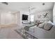 Spacious living room with a comfortable sofa, modern TV setup, and bright windows for natural light at 2860 Windsor Knoll Dr, Dacula, GA 30019