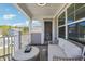 Cozy covered porch with comfortable seating, offering a relaxing outdoor space and neighborhood views at 2860 Windsor Knoll Dr, Dacula, GA 30019
