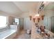 Bright bathroom featuring a soaking tub and separate glass shower at 3798 Spring Place Ct, Loganville, GA 30052