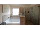 Bright bathroom featuring a soaking tub and separate glass shower at 3798 Spring Place Ct, Loganville, GA 30052