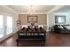 Elegant dining room with hardwood floors, chandelier lighting and seating for six at 3798 Spring Place Ct, Loganville, GA 30052