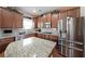 Granite countertops, stainless appliances, and wood cabinets highlight this upgraded kitchen at 3798 Spring Place Ct, Loganville, GA 30052