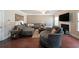 Spacious living room featuring wood floors, a ceiling fan, and a cozy fireplace at 3798 Spring Place Ct, Loganville, GA 30052