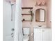 Bright bathroom featuring a shower-tub combination, wooden shelves, a mirror, and white fixtures at 836 Dill Sw Ave, Atlanta, GA 30310
