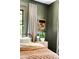 Olive-colored bedroom featuring a stylish bed, a nightstand, modern lamp and an eye-catching framed wall art at 836 Dill Sw Ave, Atlanta, GA 30310