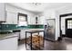 Well-lit kitchen with stainless steel appliances, emerald backsplash, granite countertops, and a center island at 836 Dill Sw Ave, Atlanta, GA 30310