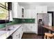 Renovated kitchen with granite countertops, stainless steel appliances, white cabinetry, and a deep basin sink at 836 Dill Sw Ave, Atlanta, GA 30310