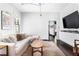 Bright living room with a large sectional sofa and a wall-mounted TV with minimalist white storage console at 836 Dill Sw Ave, Atlanta, GA 30310