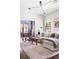 Comfortable living room with a sofa, modern lighting, and a view into the dining room at 836 Dill Sw Ave, Atlanta, GA 30310