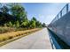 Community walkway with lush green landscaping and concrete path at 836 Dill Sw Ave, Atlanta, GA 30310