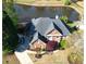 Aerial view of a brick home situated near a serene lake and lush landscaping at 870 Longstone Lndg, Alpharetta, GA 30022