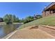 Tranquil backyard view with waterfront access, patio, retaining wall, and mature trees at 870 Longstone Lndg, Alpharetta, GA 30022