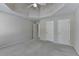 Bedroom featuring a tray ceiling, neutral tones, and carpeted flooring at 870 Longstone Lndg, Alpharetta, GA 30022