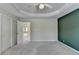 Bedroom featuring a tray ceiling, neutral tones, and carpeted flooring at 870 Longstone Lndg, Alpharetta, GA 30022