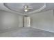 Spacious bedroom featuring a tray ceiling, neutral tones, and carpeted flooring at 870 Longstone Lndg, Alpharetta, GA 30022