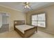 Comfortable bedroom featuring a ceiling fan, carpet and ample natural light from a large window at 870 Longstone Lndg, Alpharetta, GA 30022
