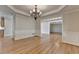 Elegant dining room features hardwood floors, wainscoting, and a decorative chandelier at 870 Longstone Lndg, Alpharetta, GA 30022