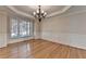 Bright dining room with hardwood floors, crown molding, large window and an elegant chandelier at 870 Longstone Lndg, Alpharetta, GA 30022