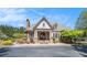 Beautiful clubhouse exterior, featuring stone accents, arched entry, and well-manicured landscaping at 870 Longstone Lndg, Alpharetta, GA 30022