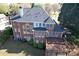 Spacious backyard with a deck featuring a well-maintained lawn and mature landscaping at 870 Longstone Lndg, Alpharetta, GA 30022