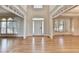 Inviting foyer with hardwood floors, grand windows, and decorative trim showcasing the open floor plan at 870 Longstone Lndg, Alpharetta, GA 30022