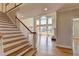 Bright foyer boasts soaring windows, hardwood floors, and a grand staircase at 870 Longstone Lndg, Alpharetta, GA 30022