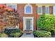 Elegant brick home showcasing a well-adorned front door with manicured landscaping and inviting entrance at 870 Longstone Lndg, Alpharetta, GA 30022