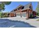 Spacious three-car garage with ample parking and access to the charming brick home at 870 Longstone Lndg, Alpharetta, GA 30022