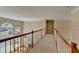 Hallway with wood railing and large windows overlooking the water at 870 Longstone Lndg, Alpharetta, GA 30022