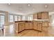Open floor plan with kitchen island, hardwood floors, and sunny breakfast area at 870 Longstone Lndg, Alpharetta, GA 30022