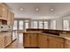Kitchen featuring wood cabinets, granite counters, stainless steel appliances, and hardwood floors at 870 Longstone Lndg, Alpharetta, GA 30022
